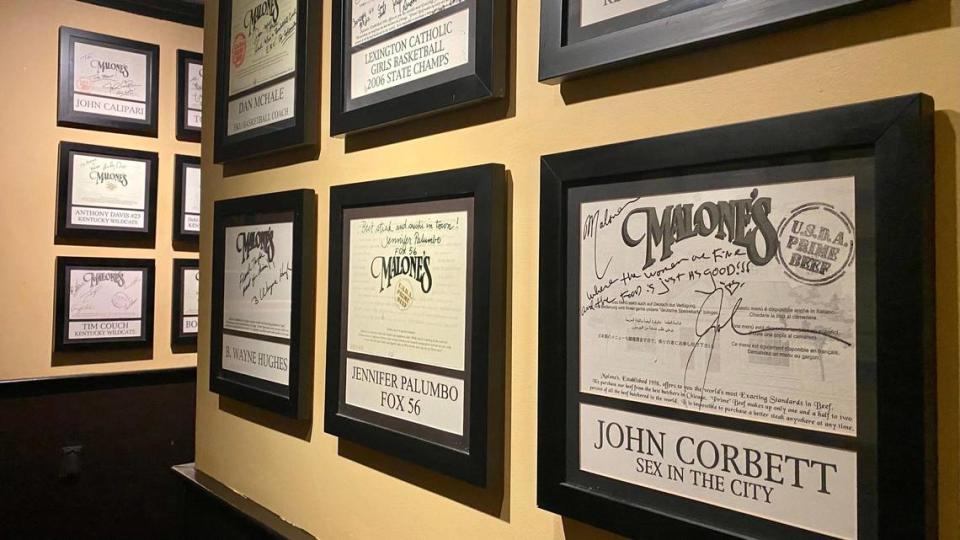 Signed menus cover the walls from notable patrons of Malone’s Lansdowne location in Lexington on June 4, 2023.