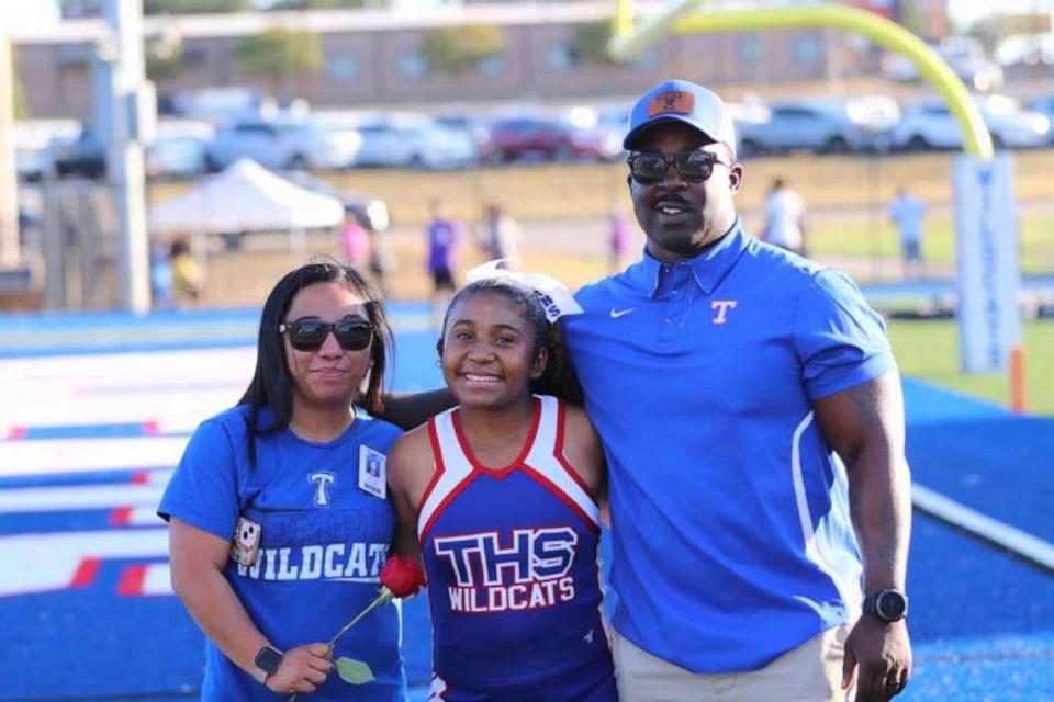 PHOTO: Jazlyn is a member of the Temple High School varsity cheer team. Here, she is pictured with her parents Cecelia and Andre Simmons. (Mike Lefner)