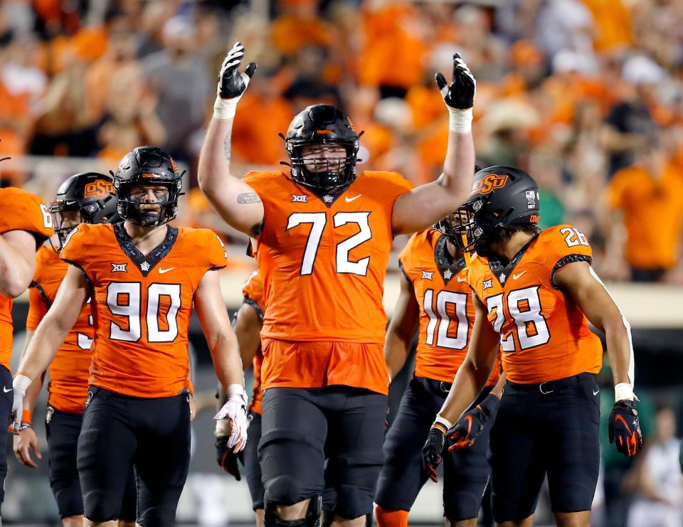 Oklahoma State's Josh Sills (72) encourages fans to cheer in the fourth quarter of a 24-14 win against Baylor on Oct. 2.