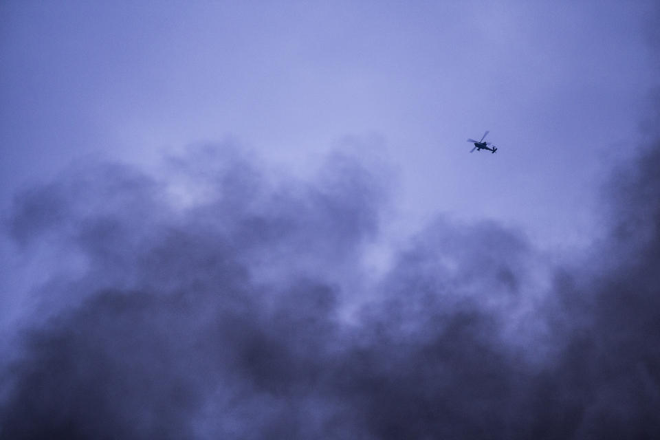 American attack helicopter flies over Hassakeh, northeast Syria, Monday, Jan. 24, 2022.Clashes between U.S.-backed Syrian Kurdish fighters and militants continued for a fourth day Sunday near the prison in northeastern Syria that houses thousands of members of IS, the Kurdish force said. (AP Photo/Baderkhan Ahmad)