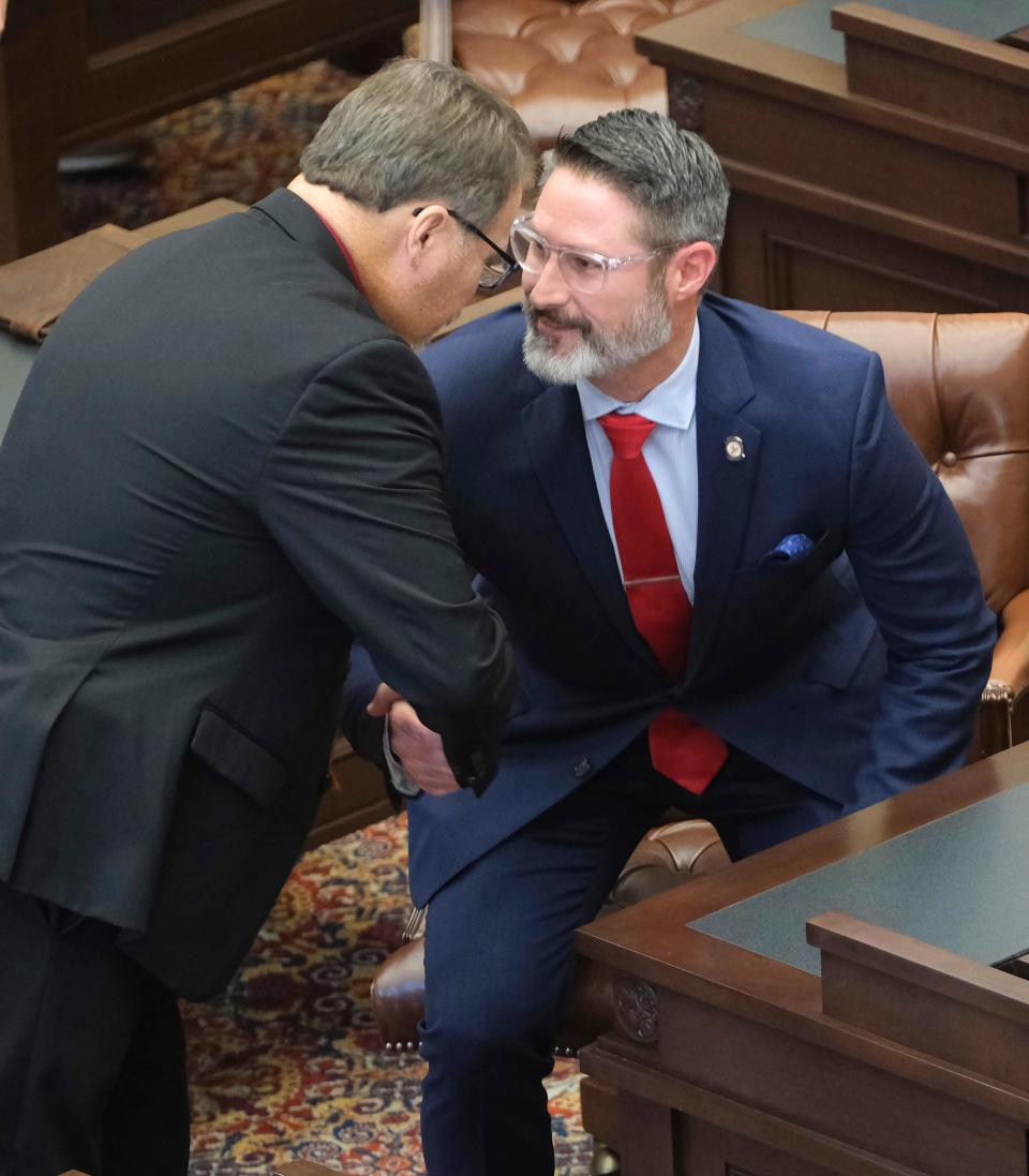 Sen. Michael Bergstrom, left, welcomes Sen. Dusty Deevers on Jan. 29, during the special session.