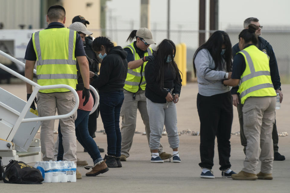 Guatemalan migrants searched before boarding a deportation flight under Title 42 authority in Harlingen, Texas Friday, May 5, 2023. Migrants have been expelled from the U.S. more than 2.8 million times since March 2020 under what is known as Title 42 authority. (AP Photo/Veronica G. Cardenas)