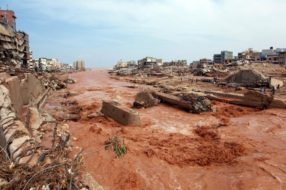 People look at the damage caused by freak floods in Derna, eastern Libya, on September 11, 2023. / Credit: AFP via Getty Images