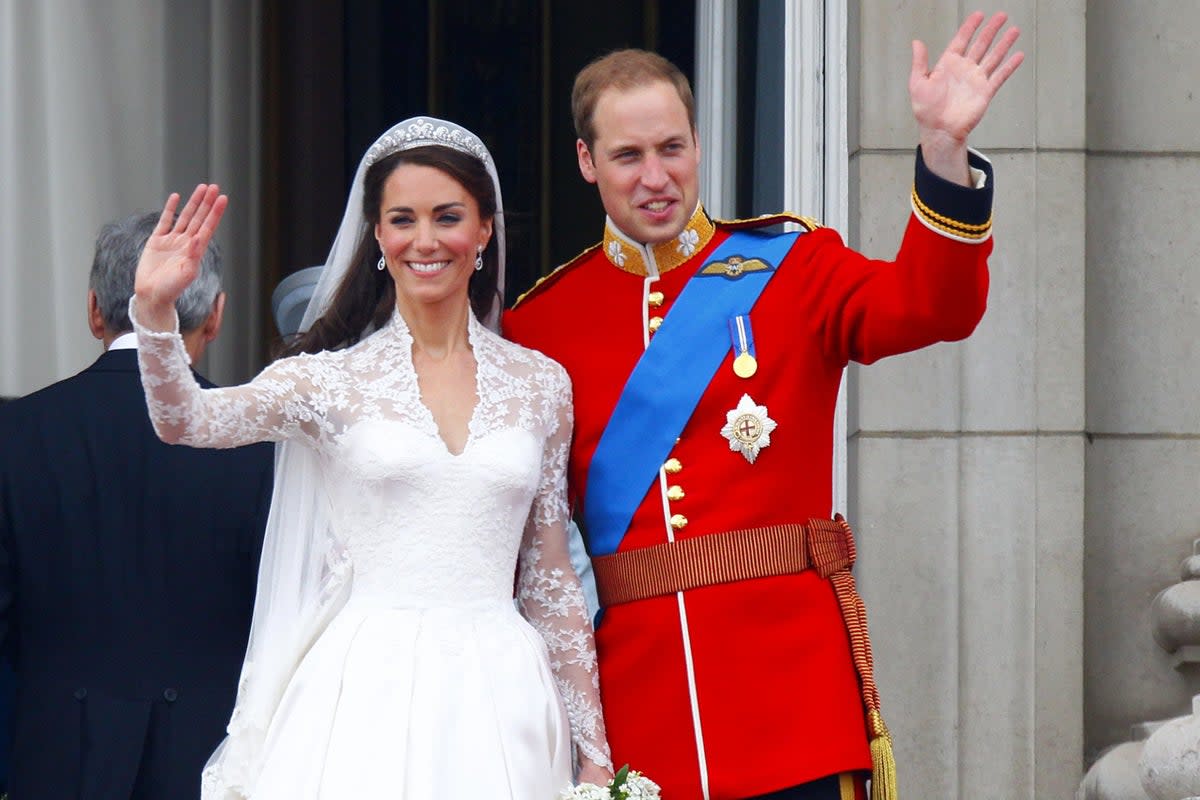 Prince William and his wife Kate wave to the crowds from the balcony of Buckingham Palace following their wedding at Westminster Abbey (PA) (PA Archive)