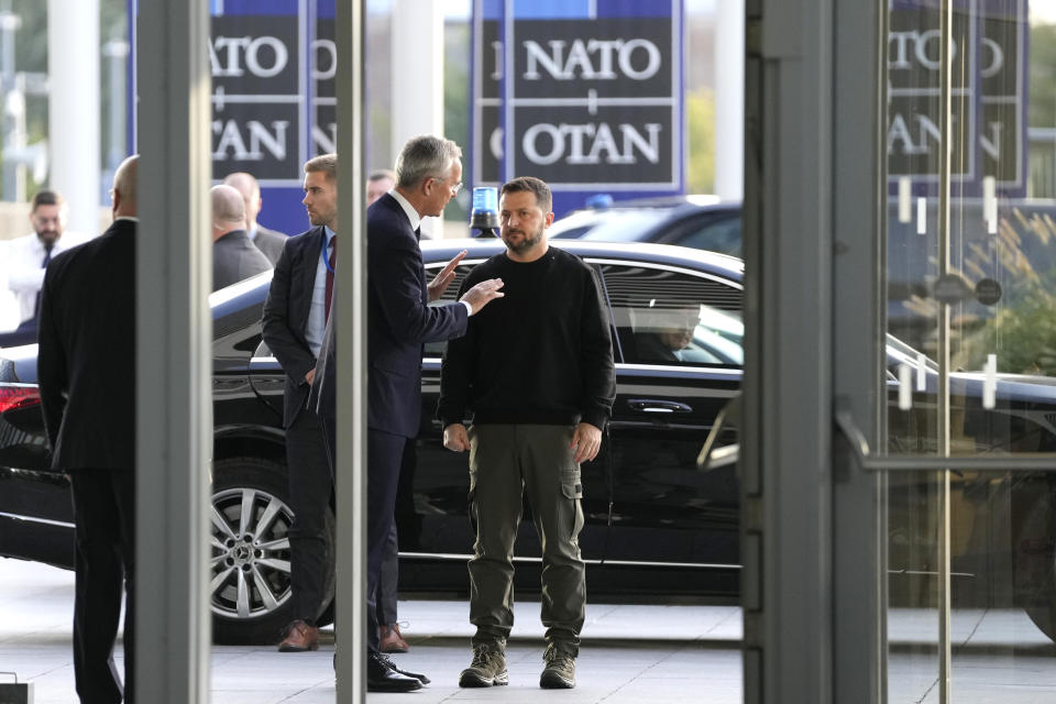 FILE - NATO Secretary General Jens Stoltenberg, center left, speaks with Ukraine's President Volodymyr Zelenskyy, right, on arrival prior to a meeting of NATO defense ministers at NATO headquarters in Brussels, Wednesday, Oct. 11, 2023. NATO is set to celebrate on Thursday, April 4, 2024, 75 years of collective defense across Europe and North America as Russia's war on Ukraine enters its third year. (AP Photo/Virginia Mayo, File)