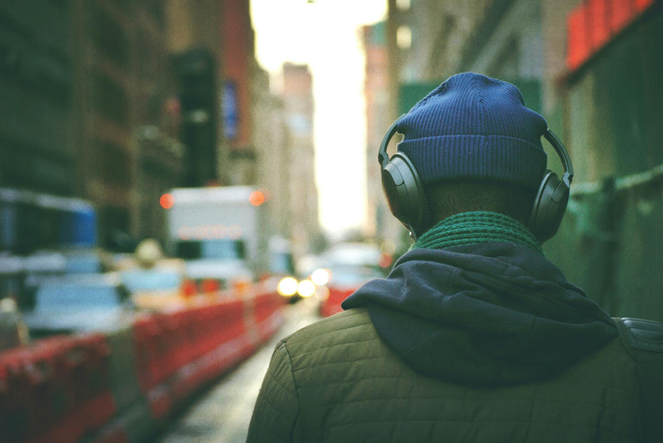 A rear view of a man with headphones on