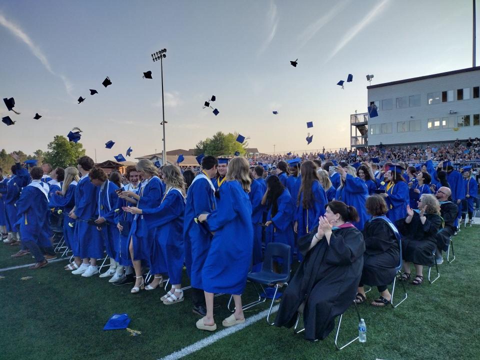 Gaylord High School graduates toss their caps at the conclusion of the 2023 graduation ceremony.