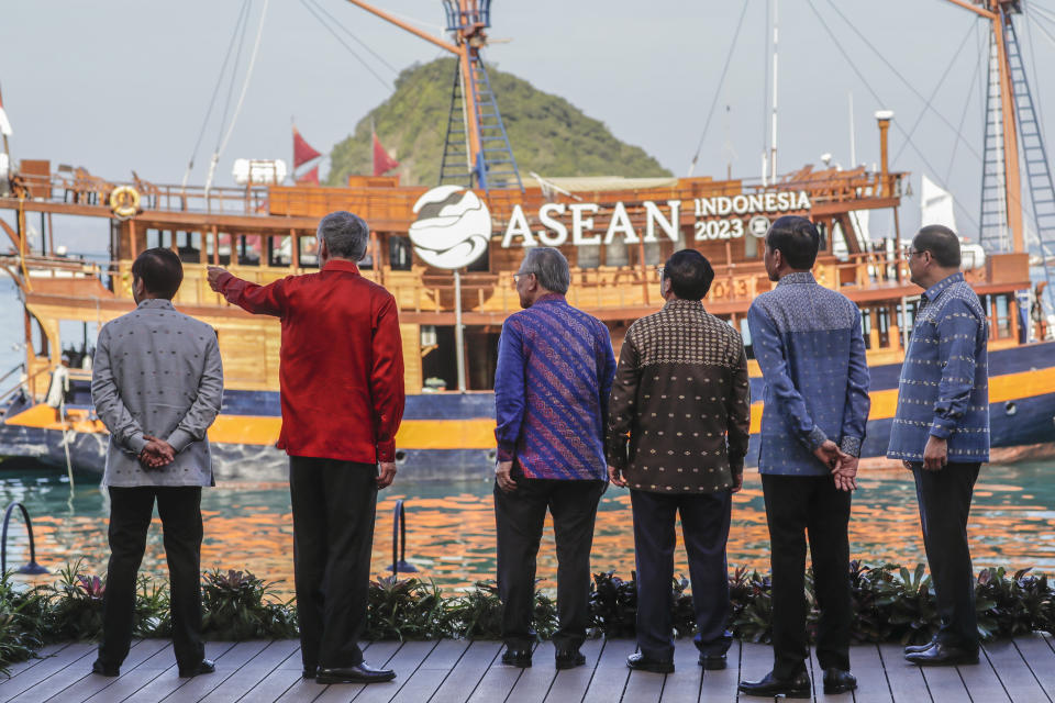 From left to right, Philippines' President Ferdinand Marcos Jr., Singapore's Prime Minister Lee Hsien Loong, Thailand's Deputy Prime Minister and Foreign Minister Don Pramudwinai, Vietnam's Prime Minister Pham Minh Chinh, Indonesia's President Joko Widodo and Laotian Prime Minister Sonexay Siphandone talk as they take their position for a family photo ahead of the retreat session at the 42nd ASEAN Summit in Labuan Bajo, East Nusa Tenggara province, Indonesia, Thursday, May 11, 2023. (Mast Irham/Pool Photo via AP)