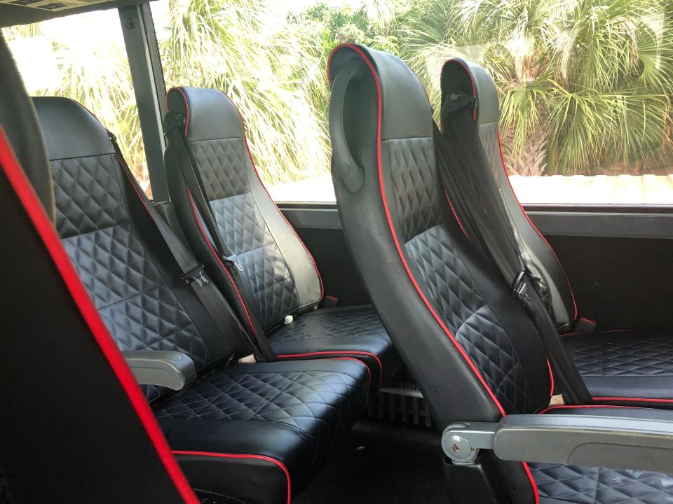 Quilted leather bus seats with red piping on the edges