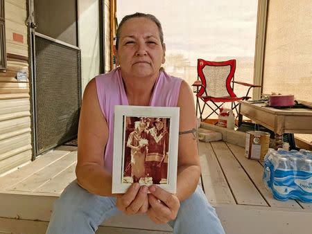 Tama DeRosier, 58, shows a photo of her husband Robert, at her mobile home in Mohave Valley, Arizona, U.S., December 3, 2017. Robert donated his body to BRC-AZ hoping it might contribute to research on diabetes. REUTERS/Reade Levinson