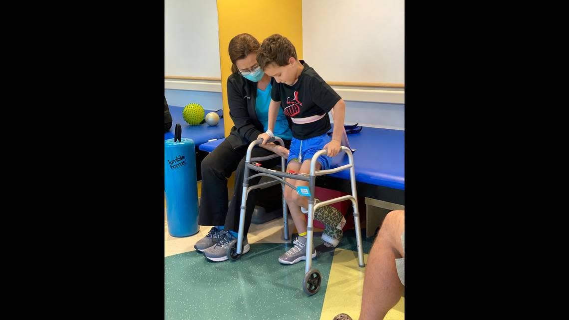 Jacob Estrada, 7, undergoes physical therapy to help regain his strength.