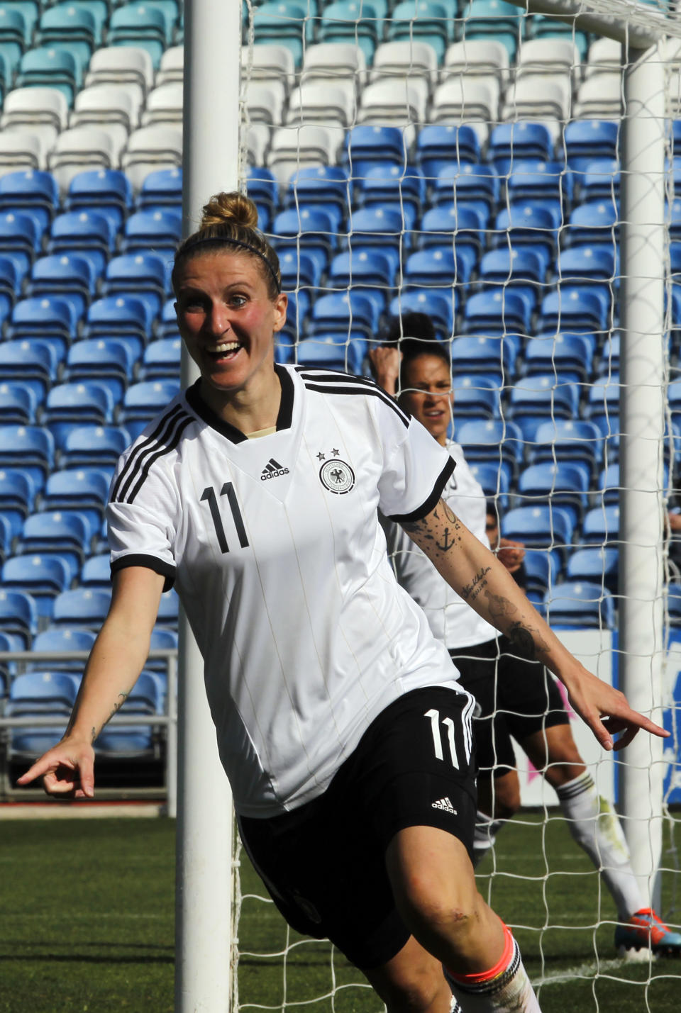 Germany's Anja Mittag celebrates after scoring her side's second goal during the women's soccer Algarve Cup final match between Germany and Japan at the Algarve stadium, outside Faro, southern Portugal, Wednesday, March 12, 2014. (AP Photo/Francisco Seco)