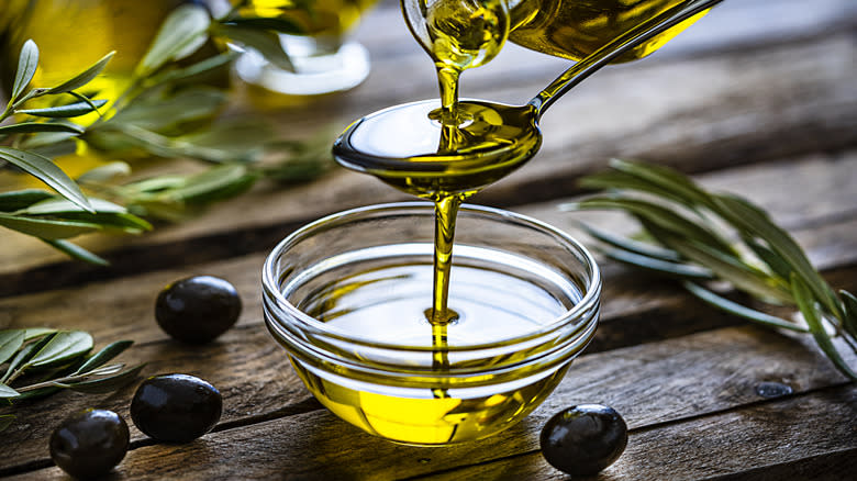 Pouring olive oil into bowl