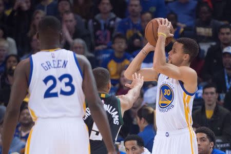 December 18, 2015; Oakland, CA, USA; Golden State Warriors guard Stephen Curry (30) shoots the basketball against Milwaukee Bucks guard Michael Carter-Williams (5) during the first quarter at Oracle Arena. Mandatory Credit: Kyle Terada-USA TODAY Sports