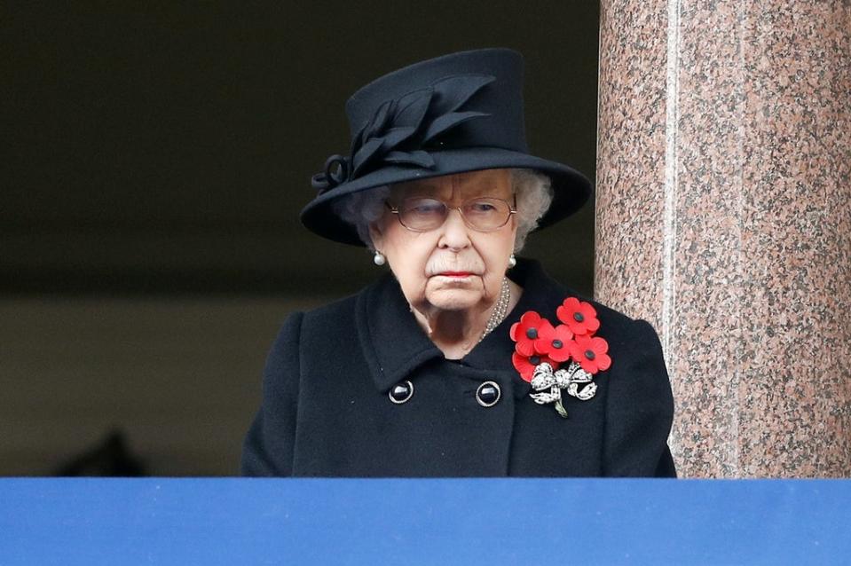 The Queen observes last year’s scaled-back service at the Cenotaph from a balcony at the Foreign, Commonwealth and Development Office building (Peter Nicholls/PA) (PA Archive)