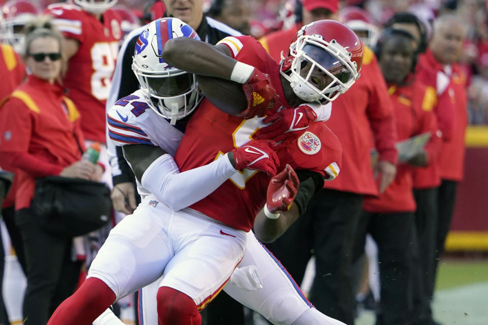 Kansas City Chiefs wide receiver JuJu Smith-Schuster, front, is tackled by Buffalo Bills cornerback Kaiir Elam during the first half of an NFL football game Sunday, Oct. 16, 2022, in Kansas City, Mo. (AP Photo/Ed Zurga)