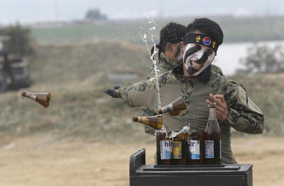 South Korean army special forces soldier breaks bottles with his hand during the Naktong River