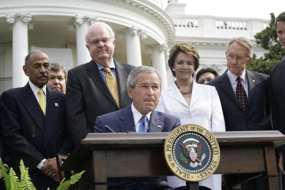 U.S. President George W. Bush signs the H.R. 9, the Fannie Lou Hammer, Rosa Parks, and Coretta Scott King Voting Rights Act Reauthorization and Amendments Act of 2006 as Rep. John Conyers (D-MI) (L), Rep. James Sensenbrenner (R-WI) (2nd L), House Minority Leader Nancy Pelosi (D-CA) (2nd R) and Senator Harry Reid (D-NV) look on July 27, 2006 in Washington, DC. (Photo by G. Fabiano-Pool/Getty Images)