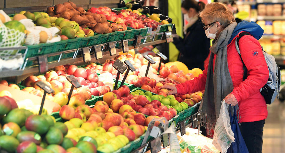 A customer wearing a protective face mask shops at a supermarket.