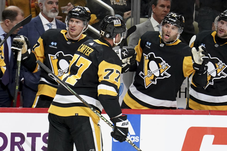 Pittsburgh Penguins' Jeff Carter (77) returns to the bench after scoring a goal against the Winnipeg Jets during the second period of an NHL hockey game, Tuesday, Feb. 6, 2024, in Pittsburgh. (AP Photo/Matt Freed)