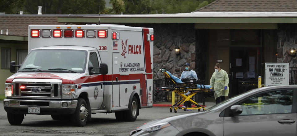 EMT's move a stretcher at the Gateway Care and Rehabilitation Center on Thursday, April 9, 2020, in Hayward, Calif. (AP Photo/Ben Margot)