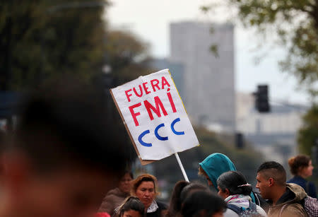 A man holds up a sign that reads “IMF (International Monetary Fund), get out” on 9 de Julio avenue during a demonstration against the government’s economic measures in Buenos Aires, Argentina September 12, 2018. REUTERS/Marcos Brindicci