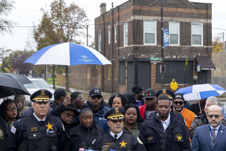 Chicago Police Commander William Betancourt, center, speaks alongside city officials and community members, Sunday, Oct. 29, 2023, at the scene of a shooting that wounded 15 people during an event in the North Lawndale neighborhood of Chicago. (Brian Cassella/Chicago Tribune via AP)