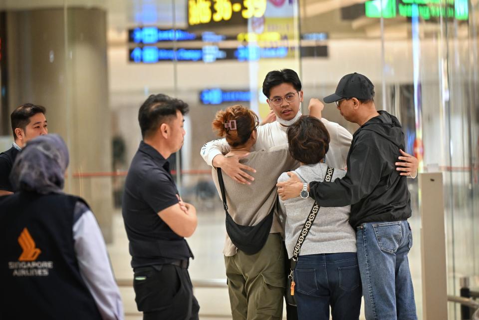 Passengers of Singapore Airlines flight SQ321, which made an emergency landing in Bangkok on its flight from London to Singapore, greet family members upon arrival (EPA)
