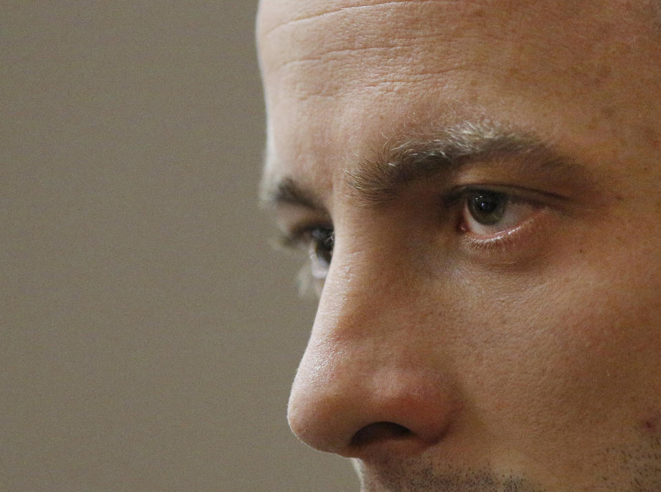 Oscar Pistorius sits in the dock on the second day of his trial at the high court in Pretoria, South Africa, Tuesday, March 4, 2014. Pistorius is charged with murder for the shooting death of his girlfriend, Reeva Steenkamp, on Valentines Day in 2013. (AP Photo/Kim Ludbrook, Pool)