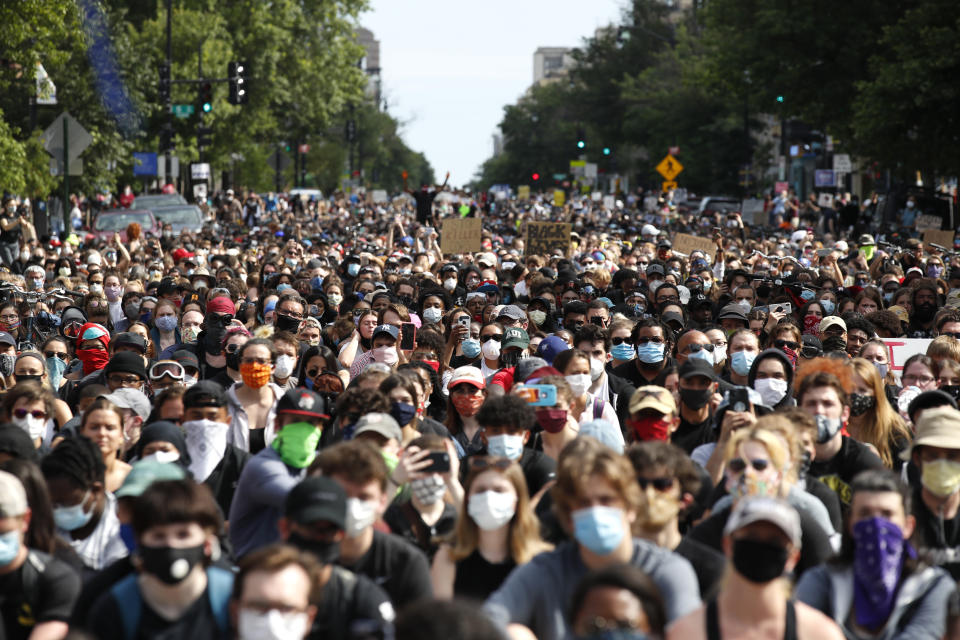 Demonstrators pause to kneel as they march to protest the death of George Floyd, Tuesday, June 2, 2020, in Washington. Floyd died after being restrained by Minneapolis police officers. (AP Photo/Alex Brandon)