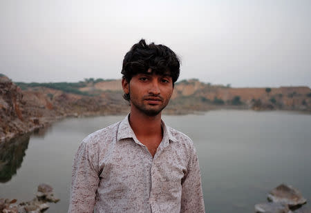 Irshad Zakir Khan poses for a photograph in a disused sandstone quarry where he used to work, near the village of Sirohi in Haryana, India, October 29, 2018. REUTERS/Alasdair Pal