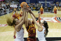 Iowa State guard Arianna Jackson (2) battles for a rebound with Texas forward Taylor Jones, left, and guard Shaylee Gonzales, right, during the first half of an NCAA college basketball game for the Big 12 tournament championship Tuesday, March 12, 2024, in Kansas City, Mo. (AP Photo/Charlie Riedel)