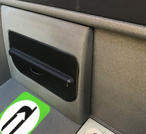 An extra panel is fitted over the receipt slot of the ATM, hiding the camera.