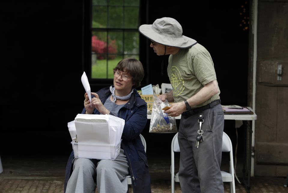 Jessica Baumert, left, executive director of The Woodlands, speaks with volunteer Joe Shapiro, in front of the former stable at The Woodlands, Saturday May 4, 2019 in Philadelphia. The cemeteries of yore existed as much the living as for the dead. And a handful of these 19th century graveyards are restoring the bygone tradition of cemetery gardening. (AP Photo/Jacqueline Larma)