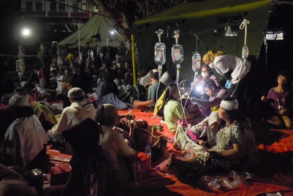 Wounded survivors of an earthquake are treated in the yard of a hospital in Cianjur (AFP/Getty)