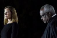 FILE - In this Oct. 26, 2020, file photo Amy Coney Barrett, left, and Supreme Court Justice Clarence Thomas listen as President Donald Trump speaks before Thomas administers the Constitutional Oath to Barrett on the South Lawn of the White House in Washington after she was confirmed by the Senate earlier in the evening. (AP Photo/Patrick Semansky, File)