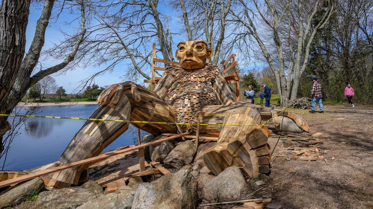 Visitors check out one of the troll statues under construction at Charlestown's Ninigret Park on Saturday.