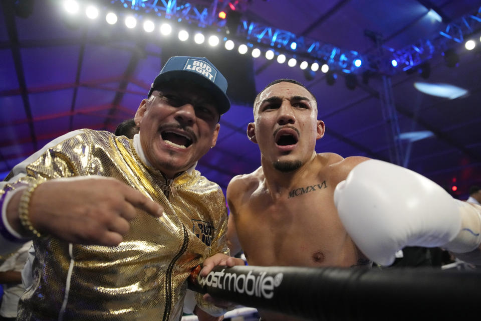 Teofimo Lopez, right, celebrates with his dad Teofimo Lopez Sr. after defeating Pedro Campa by TKO in a junior welterweight boxing match, Saturday, Aug. 13, 2022, in Las Vegas. (AP Photo/John Locher)