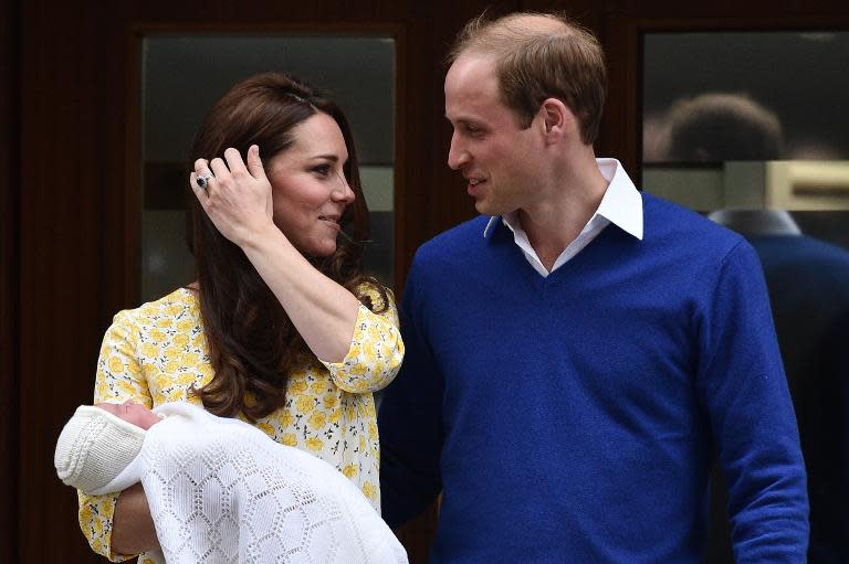 Britain's Prince William looks towards his wife Catherine, Duchess of Cambridge as they show their newly-born daughter at St Mary's Hospital in central London, on May 2, 2015