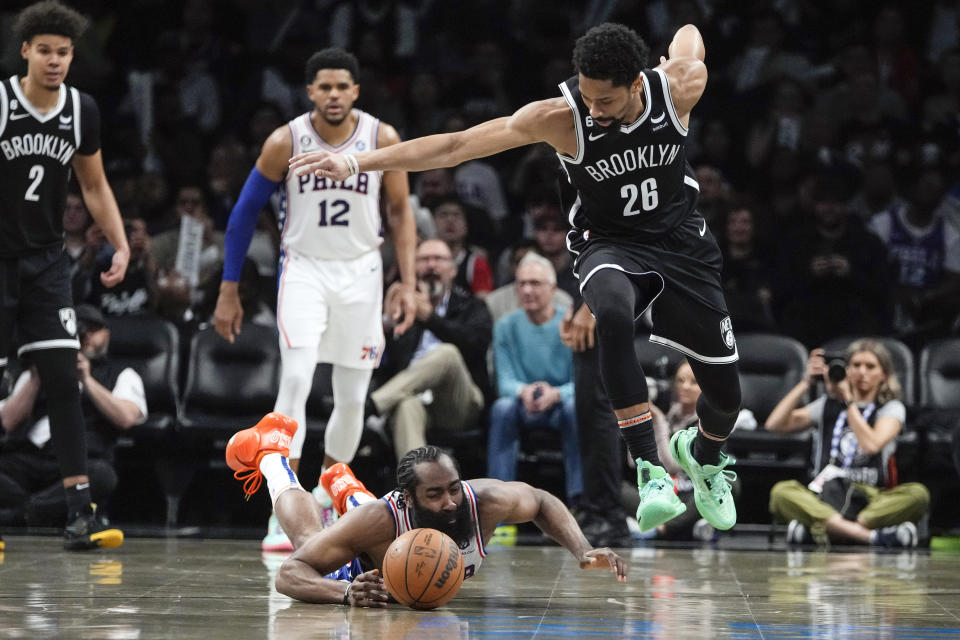 Philadelphia 76ers' James Harden, left, fights for control of the ball with Brooklyn Nets' Spencer Dinwiddie (26) during the second half of Game 4 in an NBA basketball first-round playoff series Saturday, April 22, 2023, in New York. (AP Photo/Frank Franklin II)