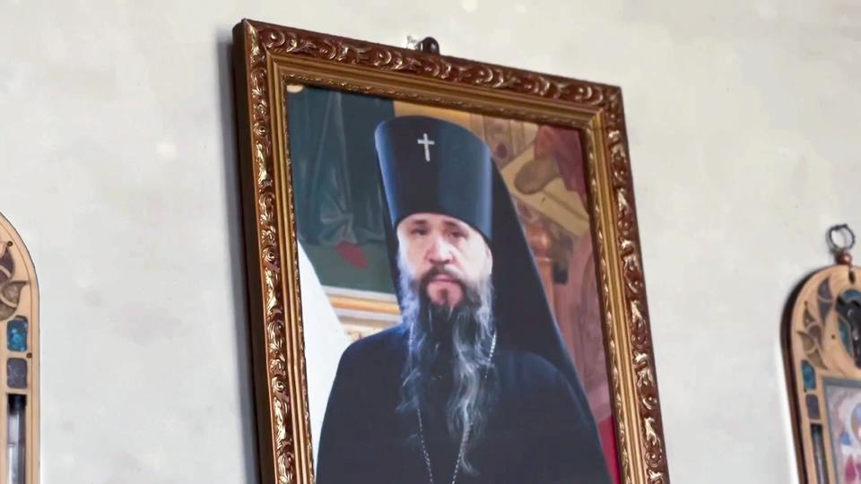 In this photo taken from video released by The Telegram Channel of the head of Dagestan Republic of Russia on Monday, June 24, 2024, A portrait of Orthodox priest Father Nikolay Kotelnikov, who was killed by armed militants, is seen on the wall the Orthodox Church of the Intercession of the Blessed Virgin Mary while the head of Dagestan Republic Sergei Melikov visiting Derbent after a counter-terrorist operation in republic of Dagestan, Russia. Multiple police officers and several civilians, including an Orthodox priest, were killed by armed militants in Russia's southern republic of Dagestan on Sunday, its governor Sergei Melikov said in a video statement early Monday. (The Telegram Channel of the head of Dagestan Republic of Russia via AP)