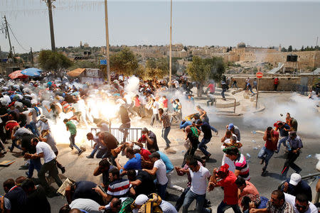 FILE PHOTO: Palestinians react following tear gas that was shot by Israeli forces after Friday prayer on a street outside Jerusalem's Old city July 21, 2017. REUTERS/Ammar Awad/File Photo