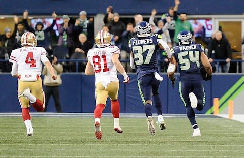 Seattle Seahawks middle linebacker Bobby Wagner (54) runs an interception back for a touchdown against San Francisco 49ers wide receiver Trent Taylor (81) in the second half at CenturyLink Field - Credit: James Snook/USA TODAY