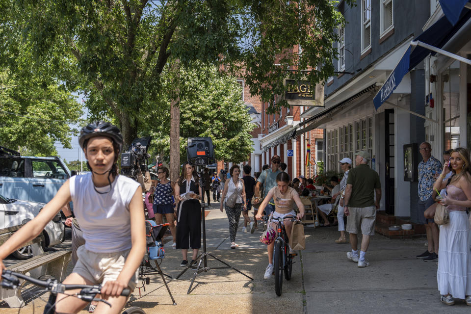 Personas a pie y en bicicleta en Main Street mientras un reportero está de pie el 18 de junio de 2024, en Sag Harbor, Nueva York. Justin Timberlake fue acusado el martes de conducir en estado de ebriedad en el pueblo frecuentado por ricos en el verano. (Foto AP/Julia Nikhinson)