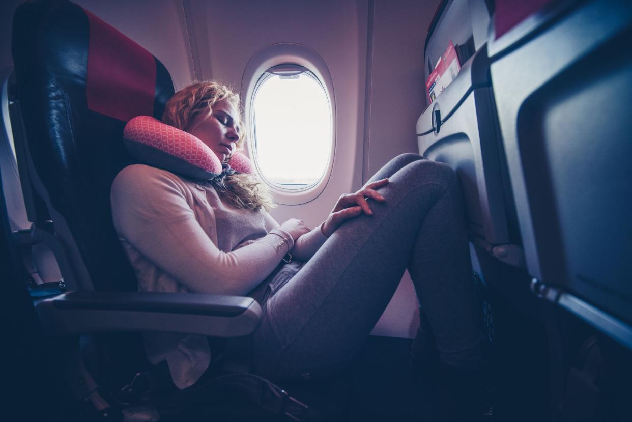 Woman napping in the plane.