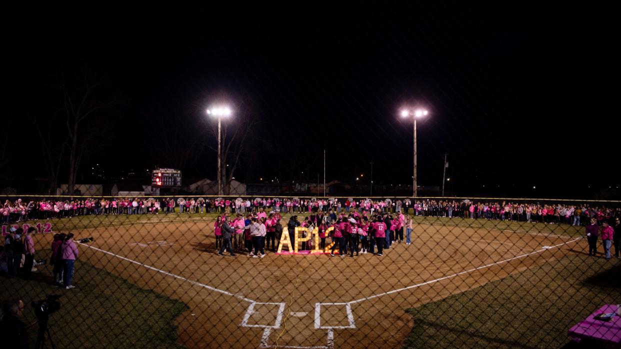 Family and friends gather for Ashton Pryor's candlelight celebration at Mike Wilson Field at Boonville High School in Boonville, Ind., Sunday evening, Feb. 19, 2023. Ashton, a softball player, wore the number 12.
