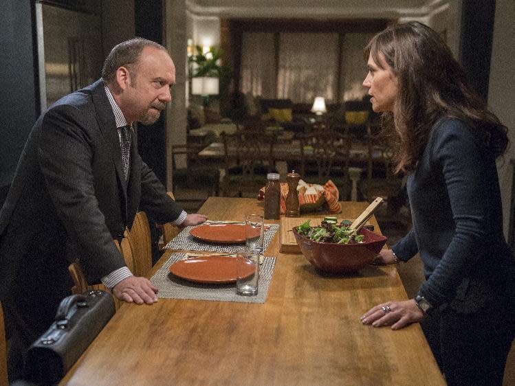 In this image released by Showtime, Paul Giamatti portrays Chuck Rhoades, left, and Maggie Siff portrays Wendy Rhoades in a scene from the series, "Billions," airing Sundays at 10 p.m. EST on Showtime. ( Jeff Neumann/Showtime via AP)