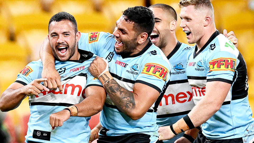 The Cronulla Sharks, pictured here in action against the Broncos.