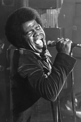 <p>Michael Ochs Archives/Getty</p> James Brown performs in 1968