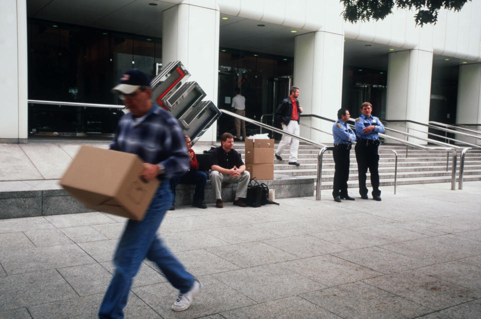 Employees remove their belongings from Enron's corporate headquarters after being laid off due to the company's collapse. (Photo: Gregory Smith via Getty Images)